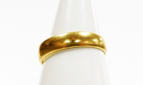 A 22ct gold wedding band, London 1911, ring size L&frac12;, 3.1g.