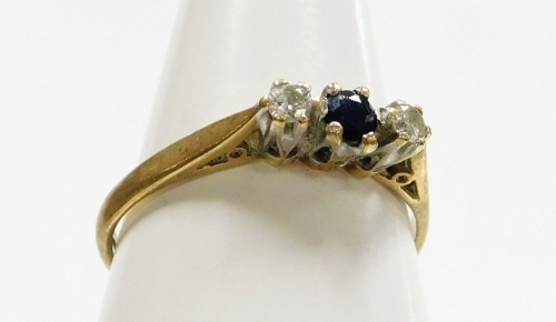 A 9ct gold three stone dress ring, set with tiny sapphire and two diamonds, each in claw setting, ring size L&frac12;, 1.4g all in.