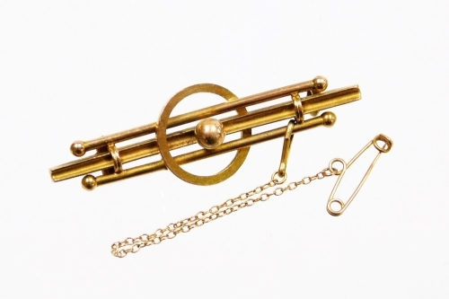 A 9ct gold bar brooch, of three bar ball design, with central ball and loop, with single pin back and safety chain, 4.5cm long, 2.4g all in.