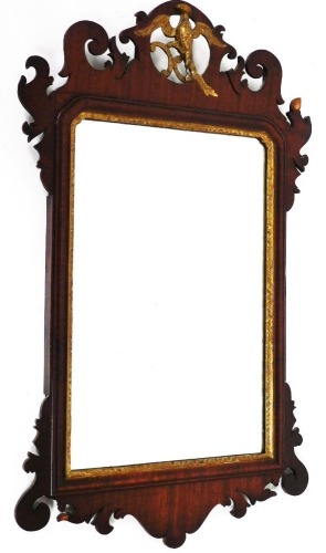 An early 19thC mahogany fret frame wall mirror, with a hoho bird crest, 74cm high, 44cm wide.