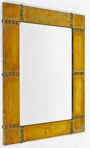 An Arts and Crafts design brass framed rectangular wall mirror, with raised ball decoration, 58cm x 46cm.