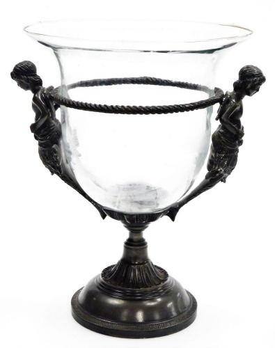 A cast metal and glass centre piece, the central clear glass removable bowl supported by two cast figures, on a circular pedestal base, 34cm high.