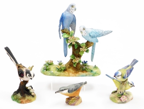 A collection of matt porcelain bird figure groups, to include a Crown Staffordshire Budgerigar group, designed and modelled by J T Jones, 22cm high, a Royal Worcester Blue Tit group, 12cm high, etc. (a quantity)
