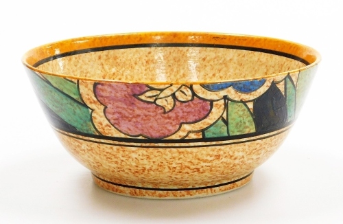 A Clarice Cliff bizarre bowl, on a mottled orange ground, decorated with flowers, leaves, etc., 17.5cm diameter.
