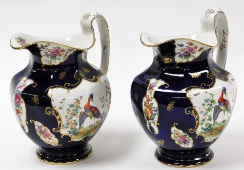 Two early 20thC Booths wash jugs, each in Scale Blue pattern with gilt detailing and Asiatic pheasants and leaves, 28cm high. (2, AF)