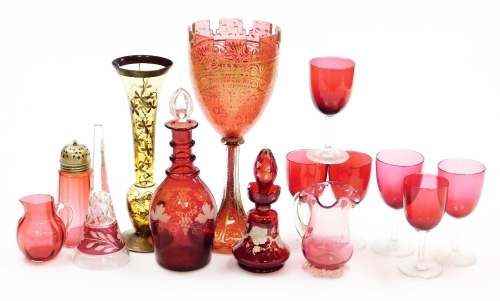 A collection of cranberry, ruby and other coloured glass, to include a ruby flash goblet, with gilt highlights, 29cm high, a quantity of cranberry drinking glasses, a cranberry flash glass decanter, the body with etched decoration with leaves, vines, etc.