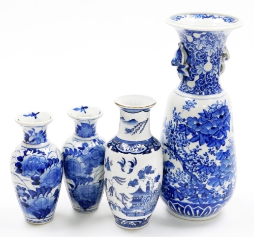 A 20thC Japanese porcelain vase, with a flared rim and bird cast handles, the body decorated with flowers, leaves, branches, etc., 33cm high, a pair of Japanese blue and white vases, 17cm high, etc.