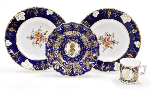 A collection of Royal Crown Derby porcelain, a pair of cabinet plates with a dark blue and gilt highlighted border decorated with vines, leaves, etc., the centre decorated with flowers, etc., 26.5cm wide, a commemorative plate to celebrate 90th birthday o