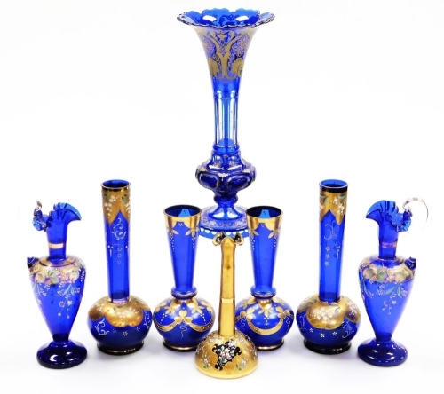 A collection of blue coloured glassware, to include a Venetian blue flash vase, with a flared rim and gilt highlights, 34cm high (AF), a pair of ewers, etc. (a quantity)