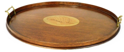 An Edwardian Sheraton Revival mahogany and inlaid two handled tray, the centre with shell inlay, 64cm wide.