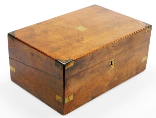A 19thC walnut and brass mounted writing box, the top with a vacant brass cartouche, the hinged lid enclosing a leather inset and fitted interior, 35cm wide
