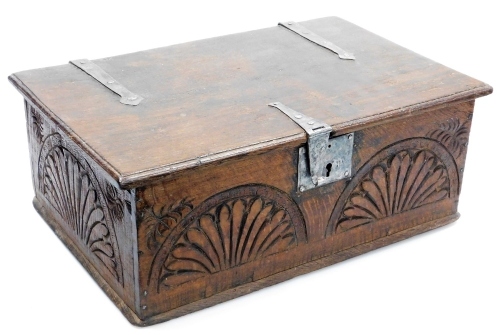 A carved oak bible box in 17thC style, with metal mounts, the hinged lid enclosing a vacant interior, 48cm wide.
