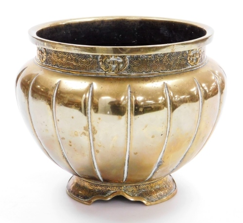 An Eastern brass jardiniere, with raised decoration and a part fluted body, 17cm high.