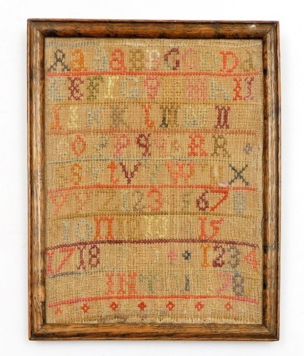 A 19thC embroidered alphabetic sampler, dated 1834, in an oak frame, 21cm x 16cm.