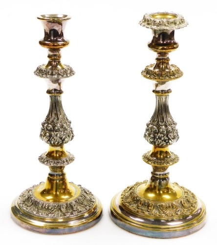 A 19thC pair of silver plated candlesticks, each with acanthus leaf stems and plain urn tops on circular feet, 30cm high. (2)