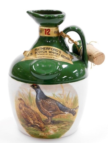 A Rutherford Scotch Whisky decanter, transfer printed with pheasants, with contents (unopened), 20cm high.