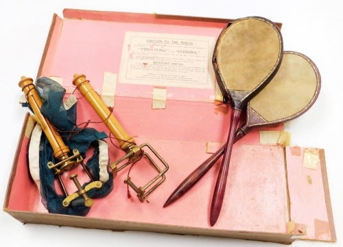 An early 20thC Gossima vintage childs ping pong game, partially boxed, with rackets, nets and other accessories, 46cm wide. (AF)