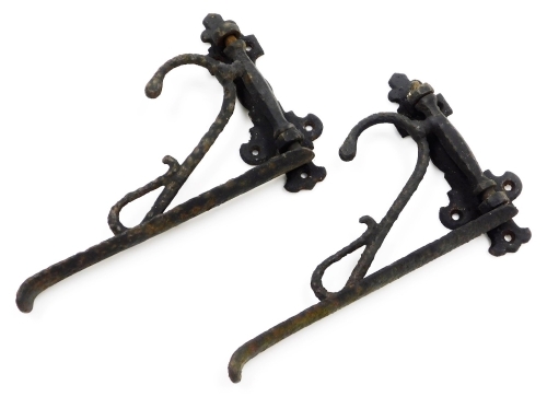 A pair of wrought iron brackets, painted black with elaborate scroll work, 28cm high. (2)