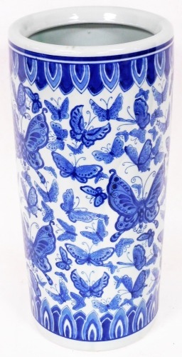 A 20thC blue and white Chinese porcelain stick barrel, of cylindrical form transfer printed with acanthus leaves and butterflies, marked beneath, 45cm high.
