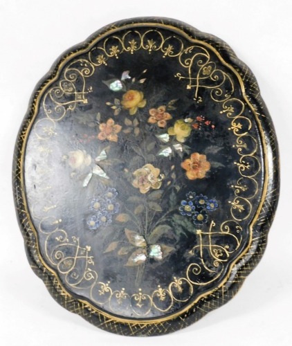 A late Victorian papier mache table top or stand, of floral shaped oval form, painted with flowers, with gilt highlights and mother of pearl inlay, 56cm x 64cm. (AF)