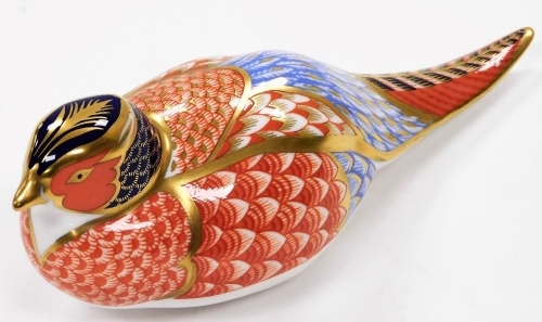 A Royal Crown Derby pheasant paperweight ornament, in Imari colours, with silver stopper, 7cm high.
