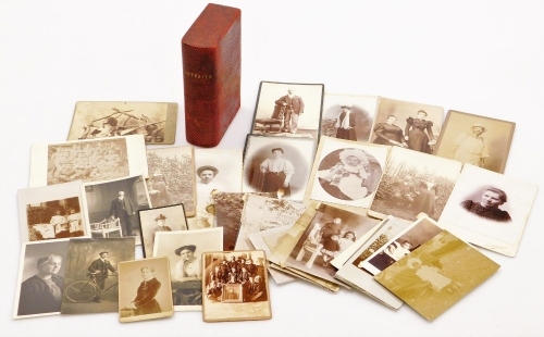 A portraits book slip case, containing various photographs, early 20thC black and white portrait photographs, child aside chair, various others, dog and gun, etc., the case 18cm high.