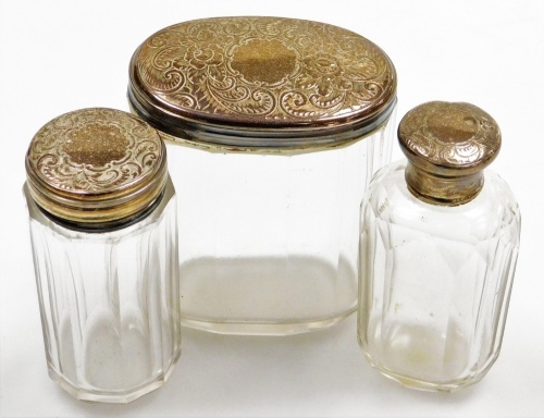An early 20thC cut glass dressing table jar, with oval plated lid, 9cm high, and two others similar. (3)