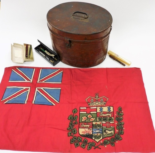 An early 20thC tin hat box, of oval form with plain interior, 38cm wide, a Japanned lacquered needle case and a quantity of various needles and an Empire flag. (a quantity)