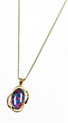 A fire opal pendant, with waved design outer border, yellow metal, marked 375, 2.5cm high, on a plated chain.