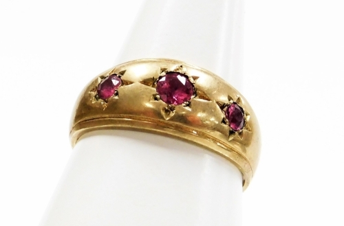 A 9ct gold three stone set dress ring, set with three rubies each in star setting, ring size S&frac12;, 3.7g all in.