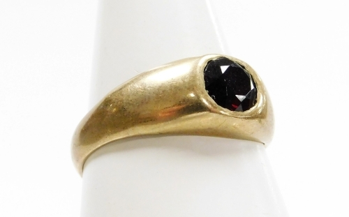 A 9ct gold dress ring, with central garnet in a rub over setting, ring size R, 3.5g all in.
