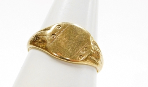 A 9ct gold gents signet ring, with floral design shoulders and central oval panel, ring size Y&frac12;, 4.3g all in.