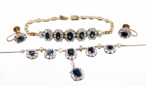 A jewellery suite, comprising necklace, earrings, and bracelet, set in silver gilt with various cluster design, the necklace with six cluster sections, on a fancy link chain, 47cm long, together with a matched bracelet, 17cm long, and a pair of screw in e