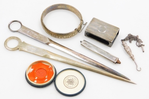 A group of silver and trinkets, to include silver card case, silver bangle, silver plated button hook, silver pencil case, silver letter opener and a plated letter opener. (a quantity)