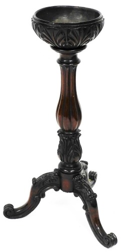 A heavily carved mahogany planter, in the George III style, the circular dish top with an acanthus leaf carving on a reeded baluster stem, terminating in further acanthus leaves with triple cabriole legs, with heavily carved tops, 91cm high, the top 26cm 