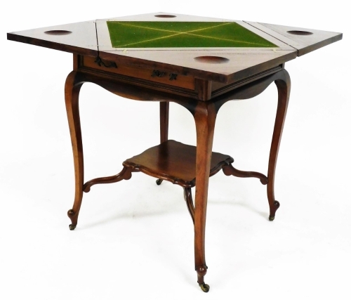 An early 20thC envelope card table, the shaped top on cabriole legs, joined by an elaborate undertier terminating in castors, 77cm high, 60cm wide, 60cm deep.