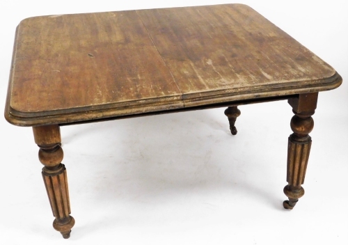 A Victorian mahogany extending dining table, on four baluster legs with castors, the canted corners, lacking leaves, 73cm high, 115cm wide, 122cm deep.