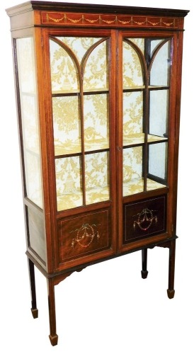 An Edwardian mahogany painted and boxwood strung display cabinet, the plain fixed cornice raised above a painted panel of garlands, above two astragal glazed doors, with further panels beneath, on square legs terminated in spade feet, 170cm high, 88cm wid