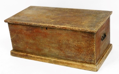 An early 20thC pine tool chest, of rectangular form, with metal side carrying handles, on a block base, 42cm high, 97cm wide, 47cm deep.