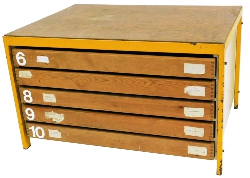 A plan chest, with applied pine effect plywood top, on yellow metal supports, with chipboard sides, above an arrangement of six drawers, 72cm high, 120cm wide, 90cm deep.