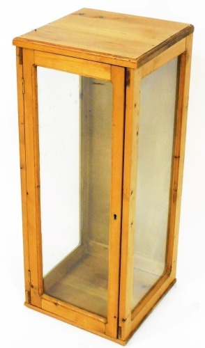 A pine glazed cabinet, of rectangular form, with plain glass panels, 81cm high, 33cm wide, 33cm deep.