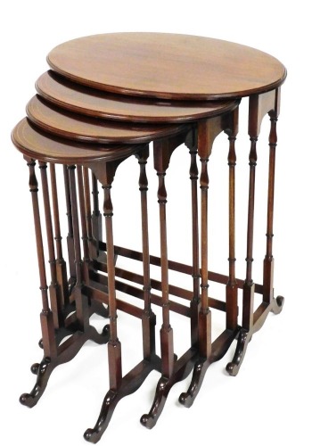 A quaretto of four Edwardian mahogany tables, each with oval tops, on turner baluster and plain stems terminating in scroll feet, the largest 73cm high, 58cm wide, 39cm deep. (4)