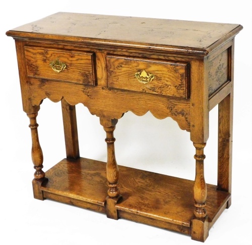 A Titchmarsh Goodwin side table, of rectangular form, with two frieze drawers, on baluster legs, terminating in block feet, 77cm high, 80cm wide, 36cm deep.