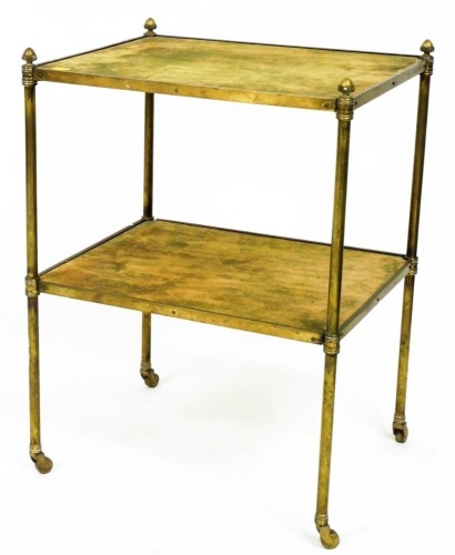 An early 20thC brass two tier trolley, on turned supports, terminating in castors, 64cm high, 48cm wide, 37cm deep.