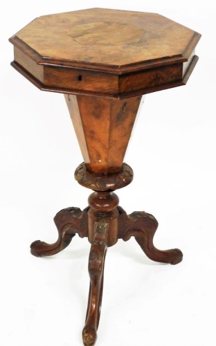 A Victorian walnut trumpet work table, of octagonal form, with fitted interior, on a heavily carved stem terminating in triple carved legs, 77cm high, 44cm wide, 44cm deep. (AF)