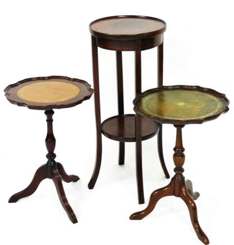 An Edwardian mahogany plant stand, the circular top raised on quadruple sabre legs, with a circular under tier, 74cm high, 33cm diameter, together with two tripod wine tables, (3).