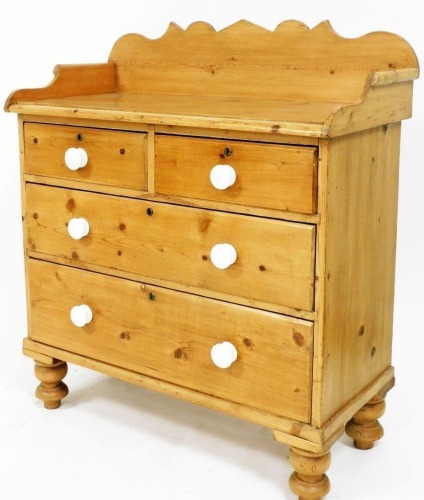 A pine chest of small proportion, the three part galleried top raised over two short and two long drawers, on bun feet, 92cm wide, 45cm deep, 99cm high..
