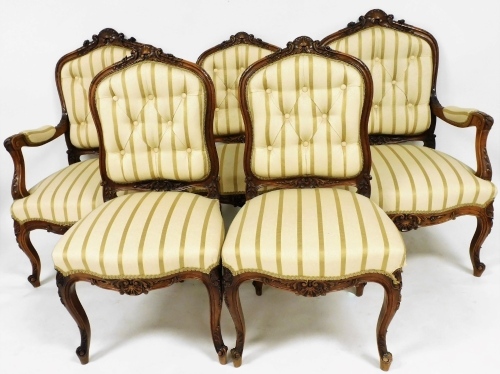 A part French salon suite, each centred by shell carvings, with Regency style striped button backs and seats, on cabriole front legs, heavily carved with scrolls and flowers, two with arms, 100cm high. (5)