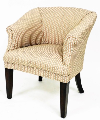 An Edwardian mahogany tub chair, overstuffed in floral striped material, on square tapering front and sabre back legs, 79cm high.