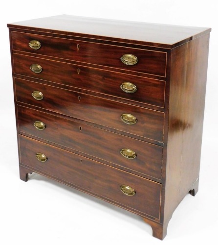 A George II mahogany secretaire chest, with two long dummy drawers, raised above three further long drawers, each with plate back handles, on shaped feet, with a fitted part satinwood interior, with removable book style cupboards, 110cm high, 111cm wide, 